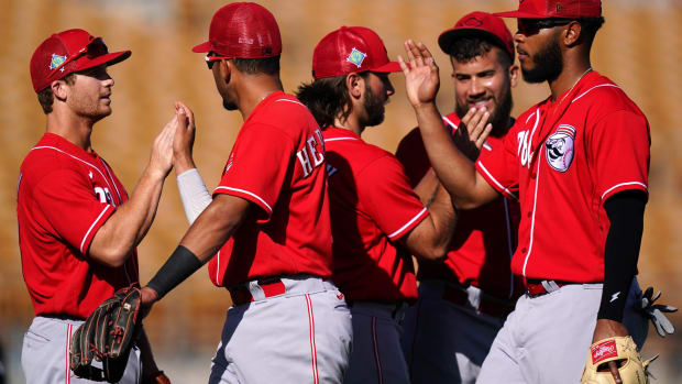 Cincinnati Reds shortstop Matt McLain (93), Cincinnati Reds infielder Miguel Hernandez (69), Cincinnati Reds infielder Max Schrock (32) and Cincinnati Reds infielder Cristian Santana (78) celebrate the win against the Los Angeles Dodgers at the conclusion of a spring training game, Tuesday, March 22, 2022, at Camelback Ranch in Glendale, Ariz. Cincinnati Reds At Los Angeles Dodgers March 22 0426  